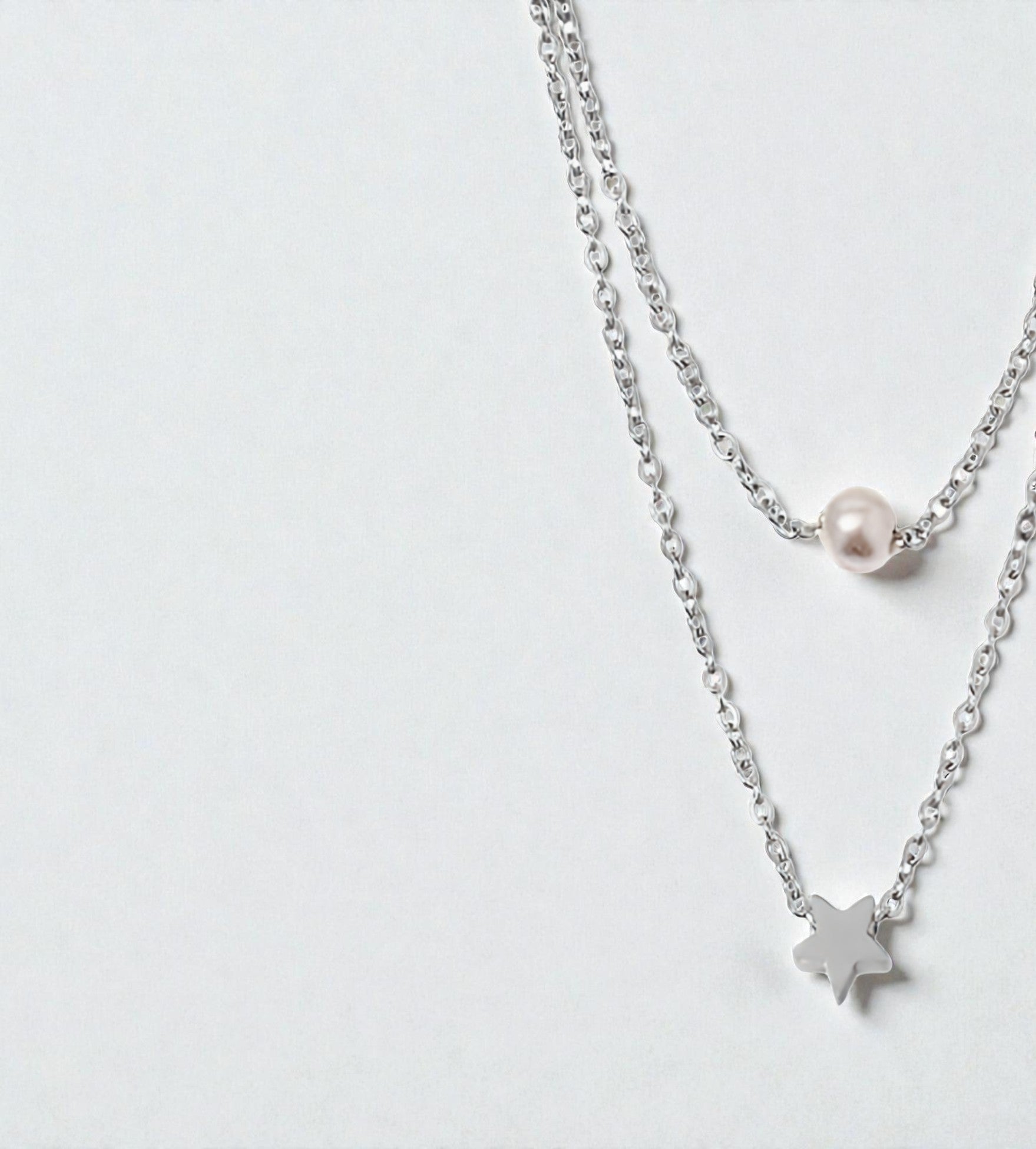 Duo de colliers dorés avec pendentif étoile et perle