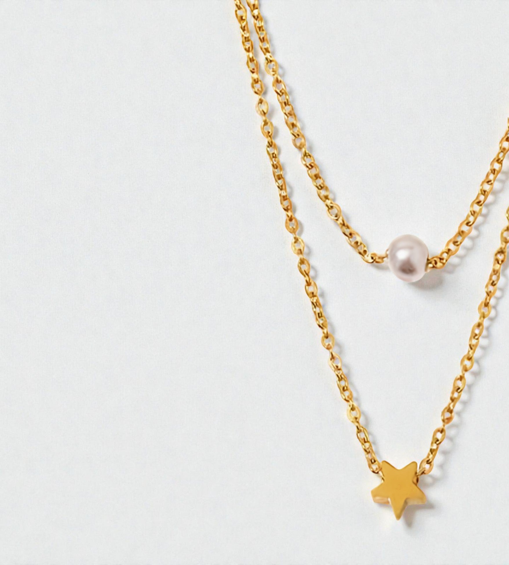 Duo de colliers dorés avec pendentif étoile et perle